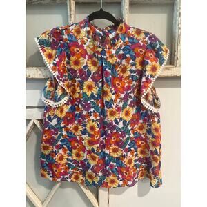 THML size medium floral print top with flutter sleeves and a button-back closure